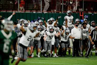 Denton Guyer celebrates a 38-31 double overtime win against Arlington after a high school...