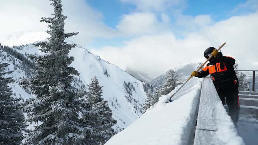 Workers have a new winter chore at Colorado's Aspen Highlands: scraping the snow off the...