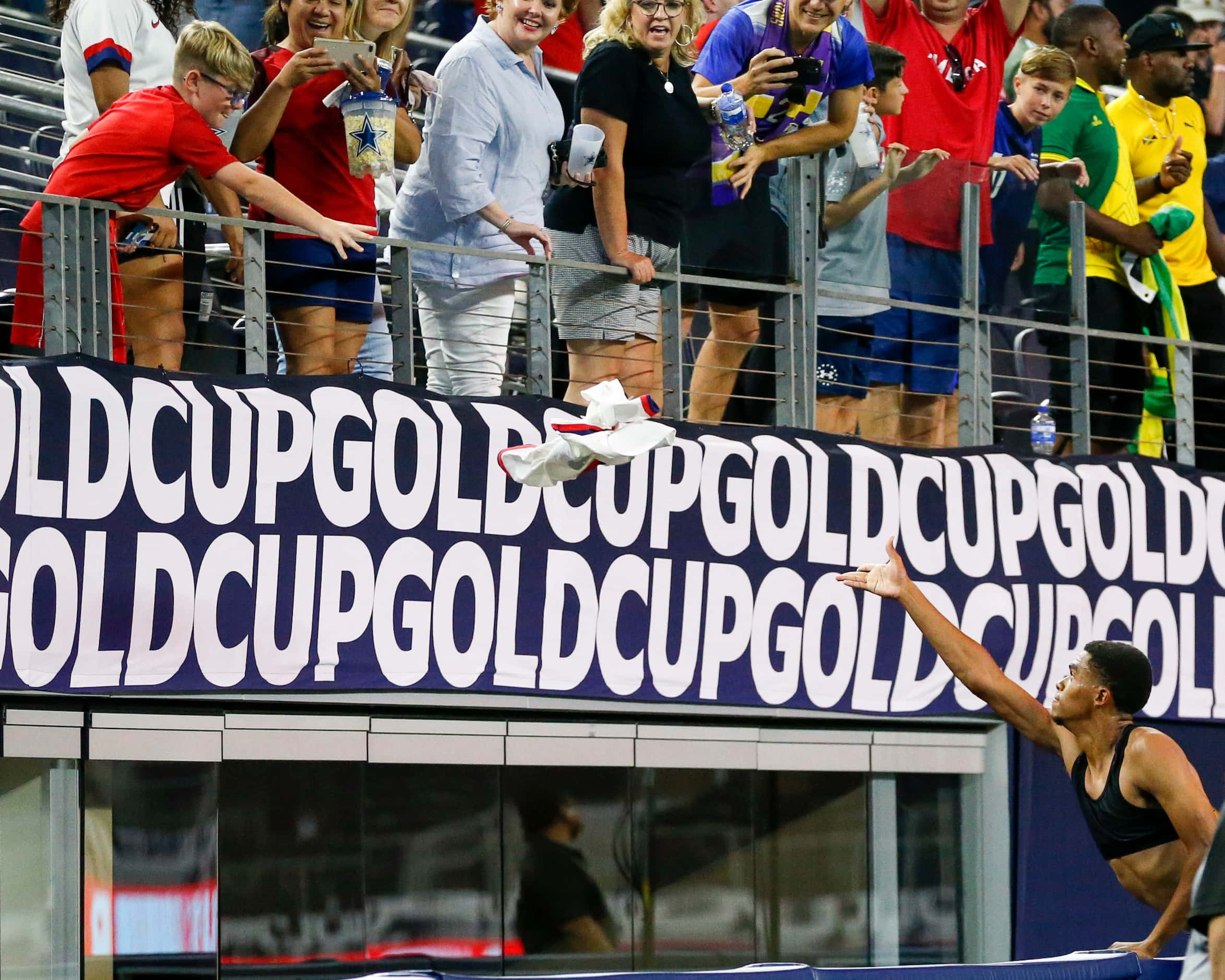 USA defender Reggie Cannon (2) tosses his jersey to a young fan after a CONCACAF Gold Cup...