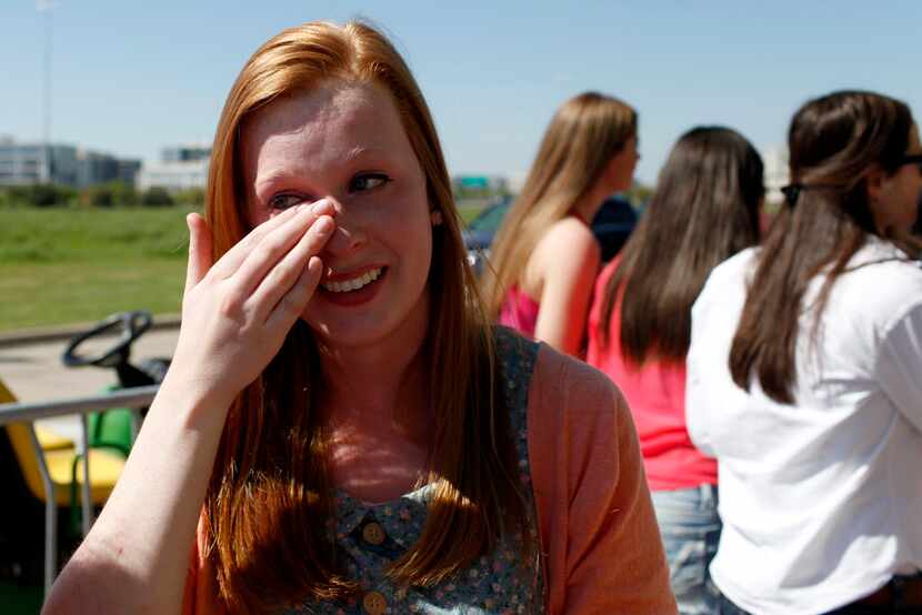 Sarah Young of Burleson wipes a tear from her cheek after meeting the band.