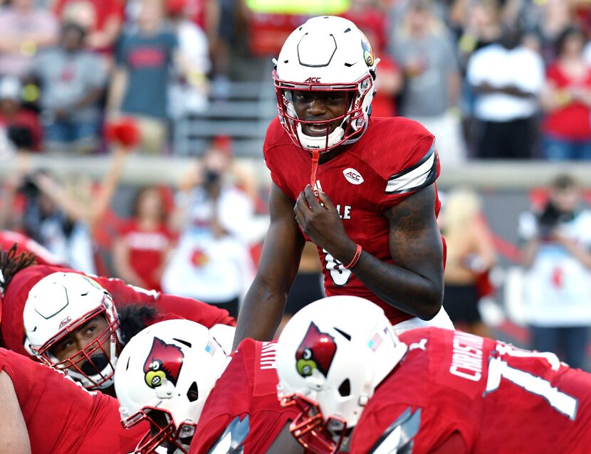 FILE - In this Sept. 1, 2016, file photo, Louisville quarterback Lamar Jackson calls out at...