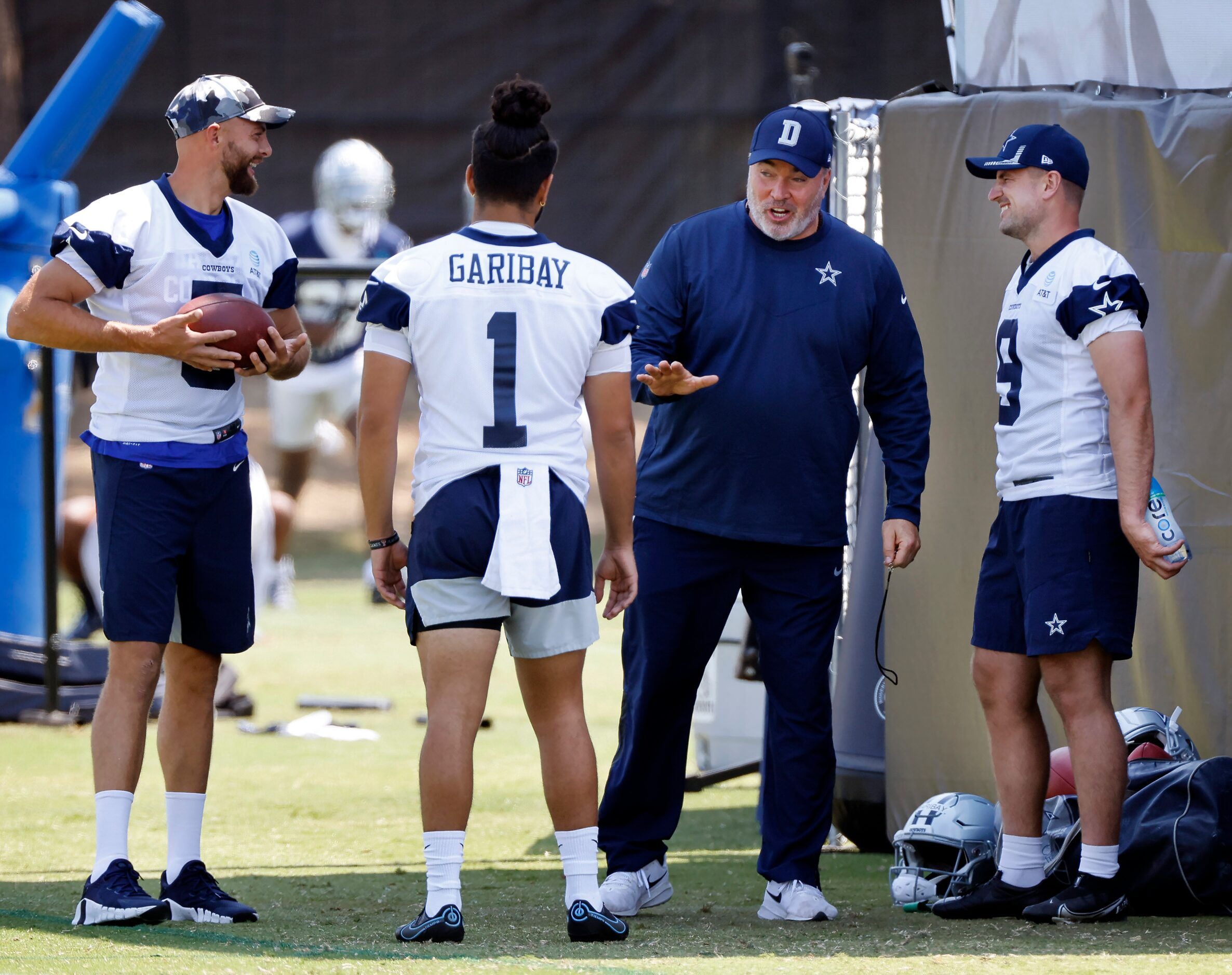 Dallas Cowboys head coach Mike McCarthy jokes with punter Bryan Anger (left), kicker...