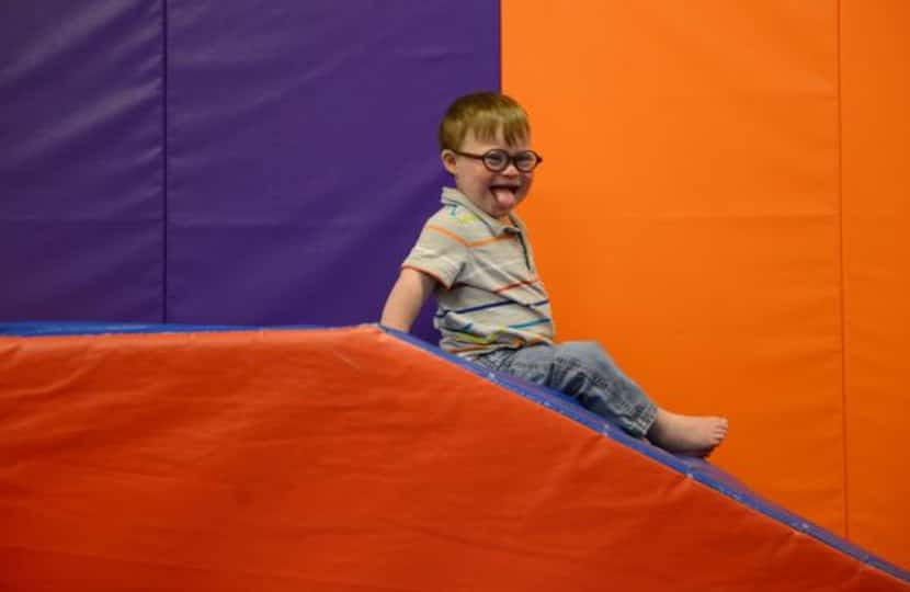 
Ben Woodard, moves down the slide during the Bridge Group class offered at The Warren Center.
