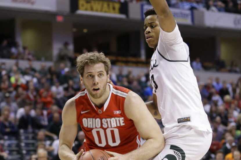 Ohio State's Mickey Mitchell (00) drives past Michigan State's Deyonta Davis (23) during the...