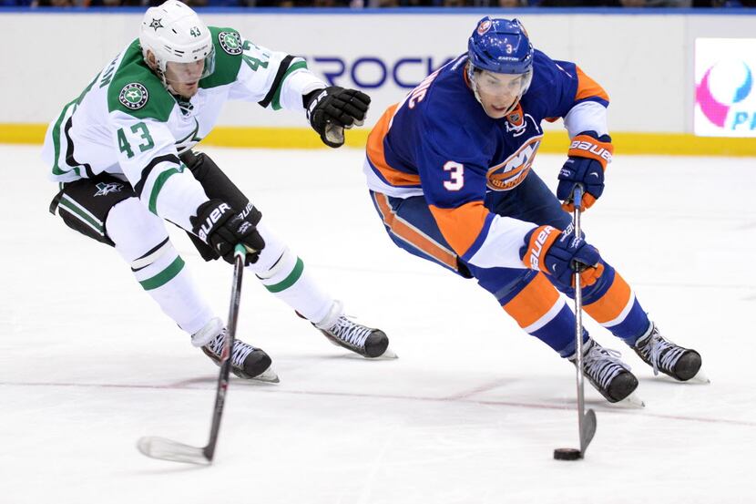 Jan 6, 2014; Uniondale, NY, USA; New York Islanders defenseman Travis Hamonic (3) gets away...