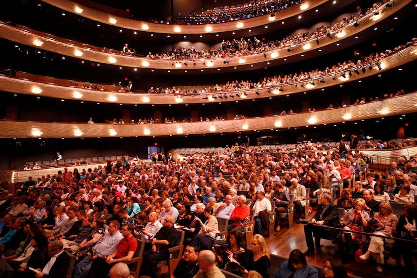 Theater patrons wait before the start of a Thursday night showing of the musical Spring...