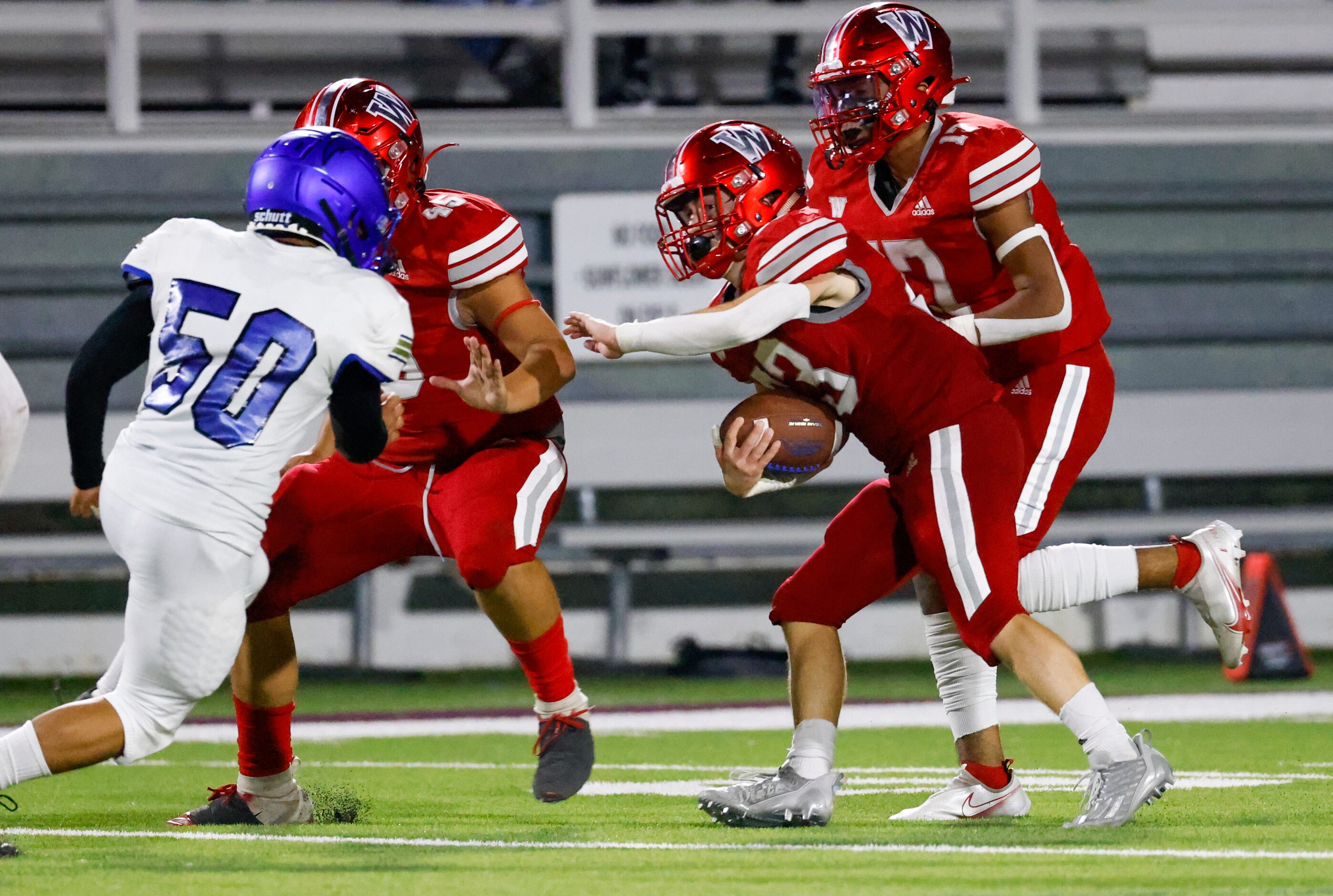 Woodrow Wilson defensive back Riley Adams (23) carries an intercepted pass down the field...