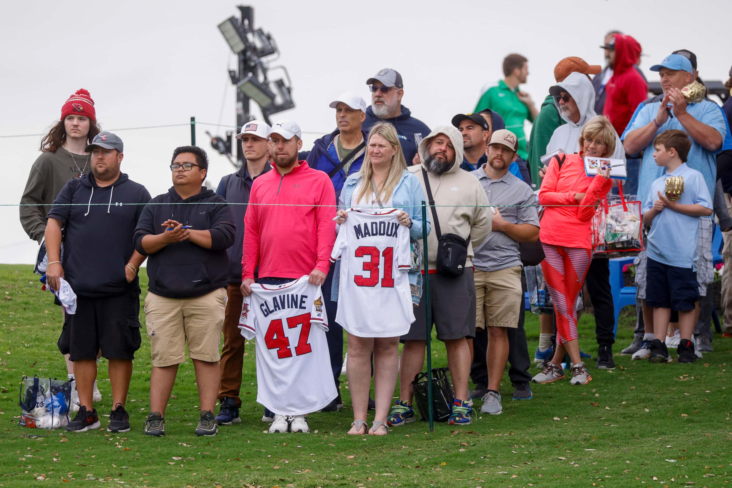 Fans watch as former MLB pitchers Greg Maddux and Tom Glavine play the 9th hole during the...
