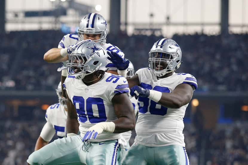 Dallas Cowboys defensive end Demarcus Lawrence (90) celebrates his sack of New York Giants...