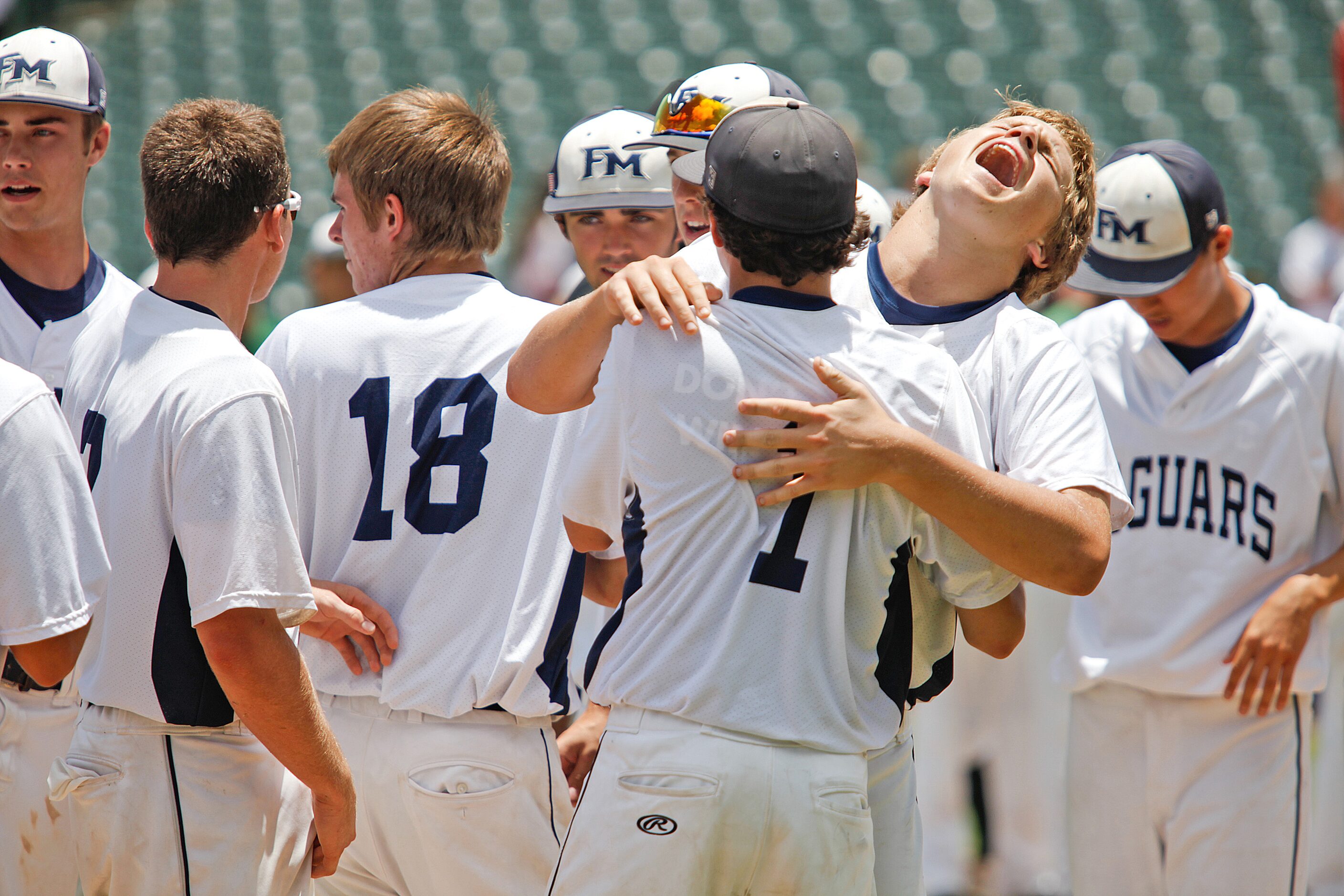 Flower Mound player Tim Millard (3, top right, facing camera) playfully celebrates during...