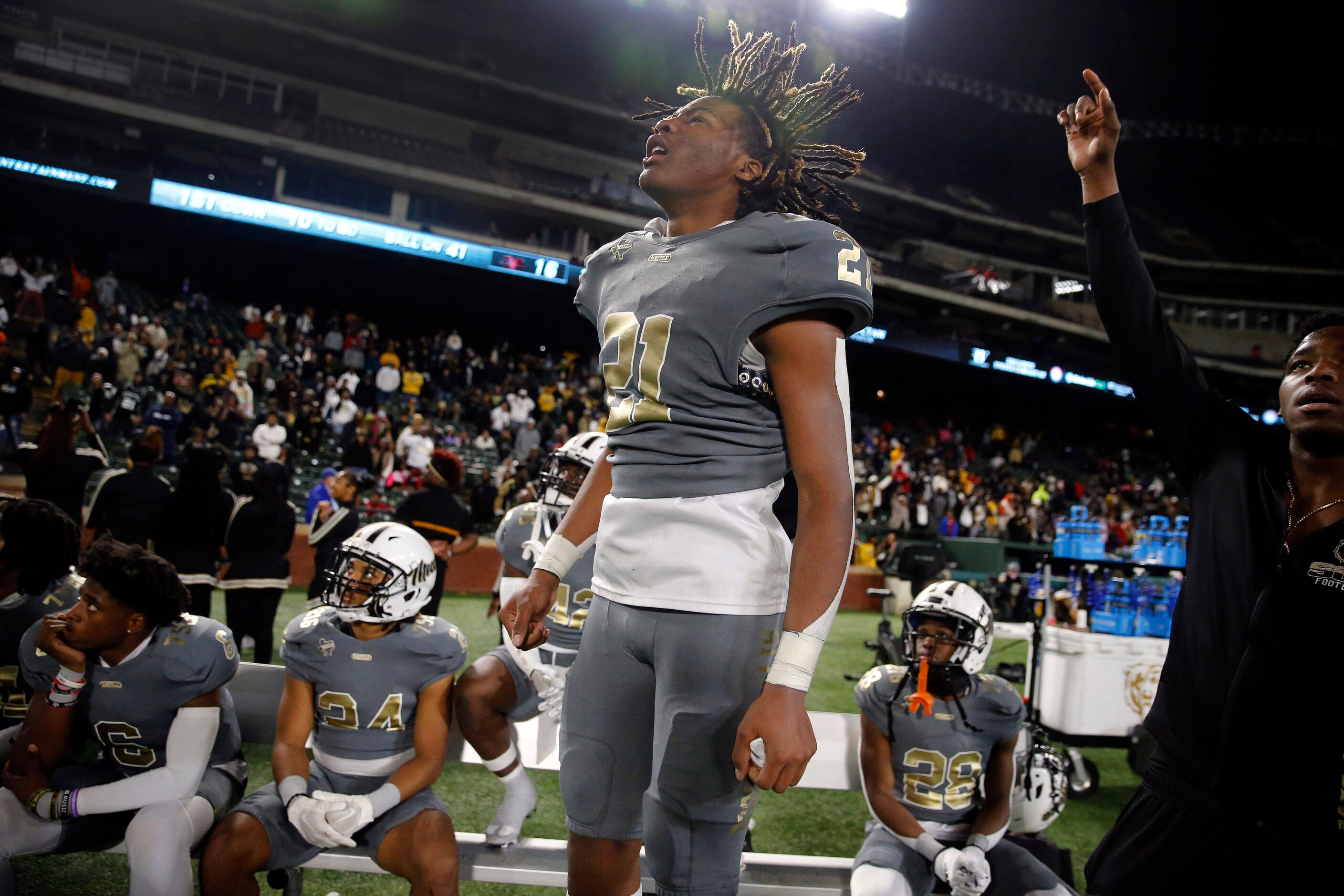 South Oak Cliff running back Danny Green (21) leaps up and down as he watches the defense...