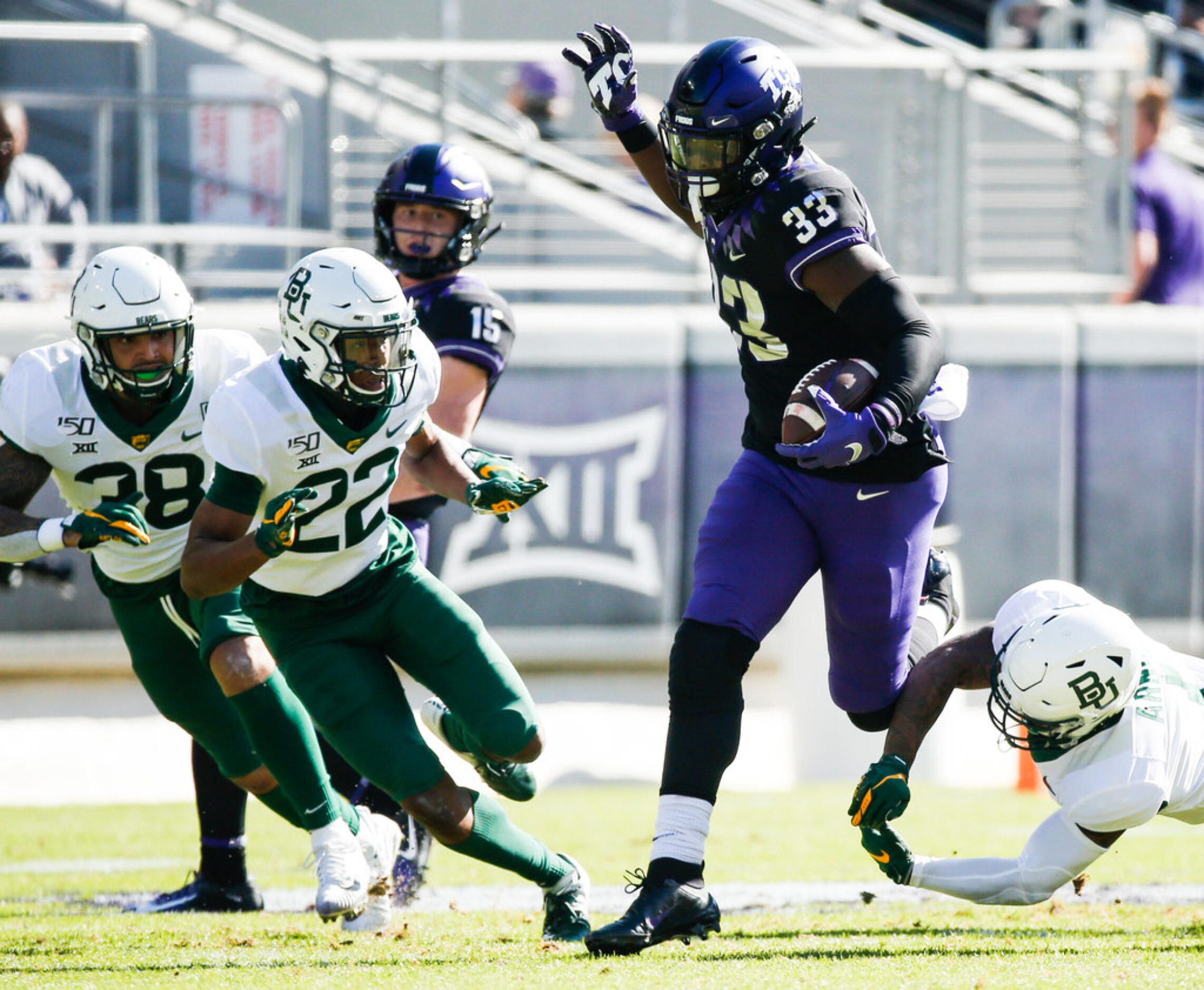 TCU Horned Frogs running back Sewo Olonilua (33) runs a lane past Baylor Bears linebacker...