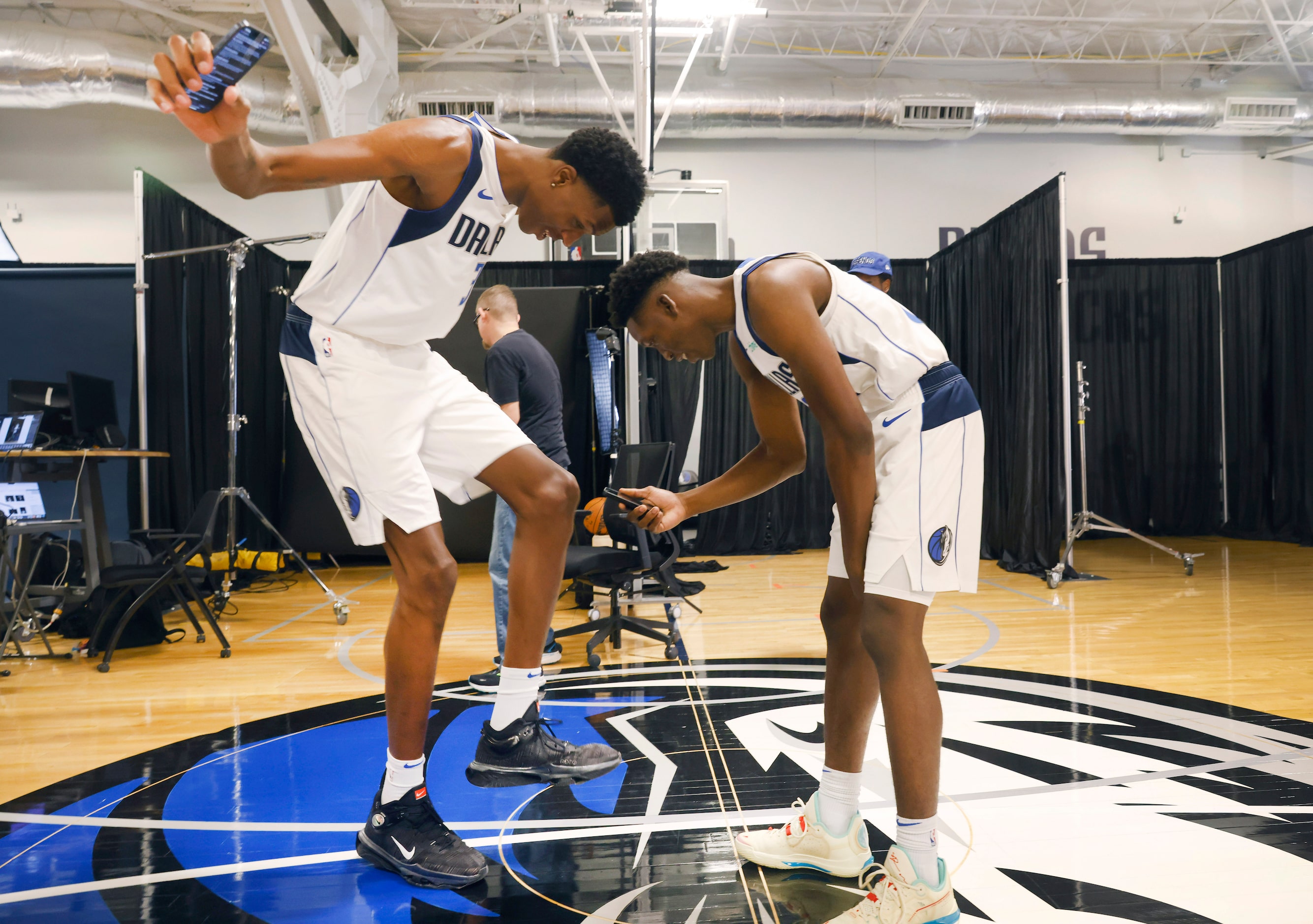 Dallas Mavericks guard Jazian Gortman (00, right) takes video of 7-foot, 5-inch center...