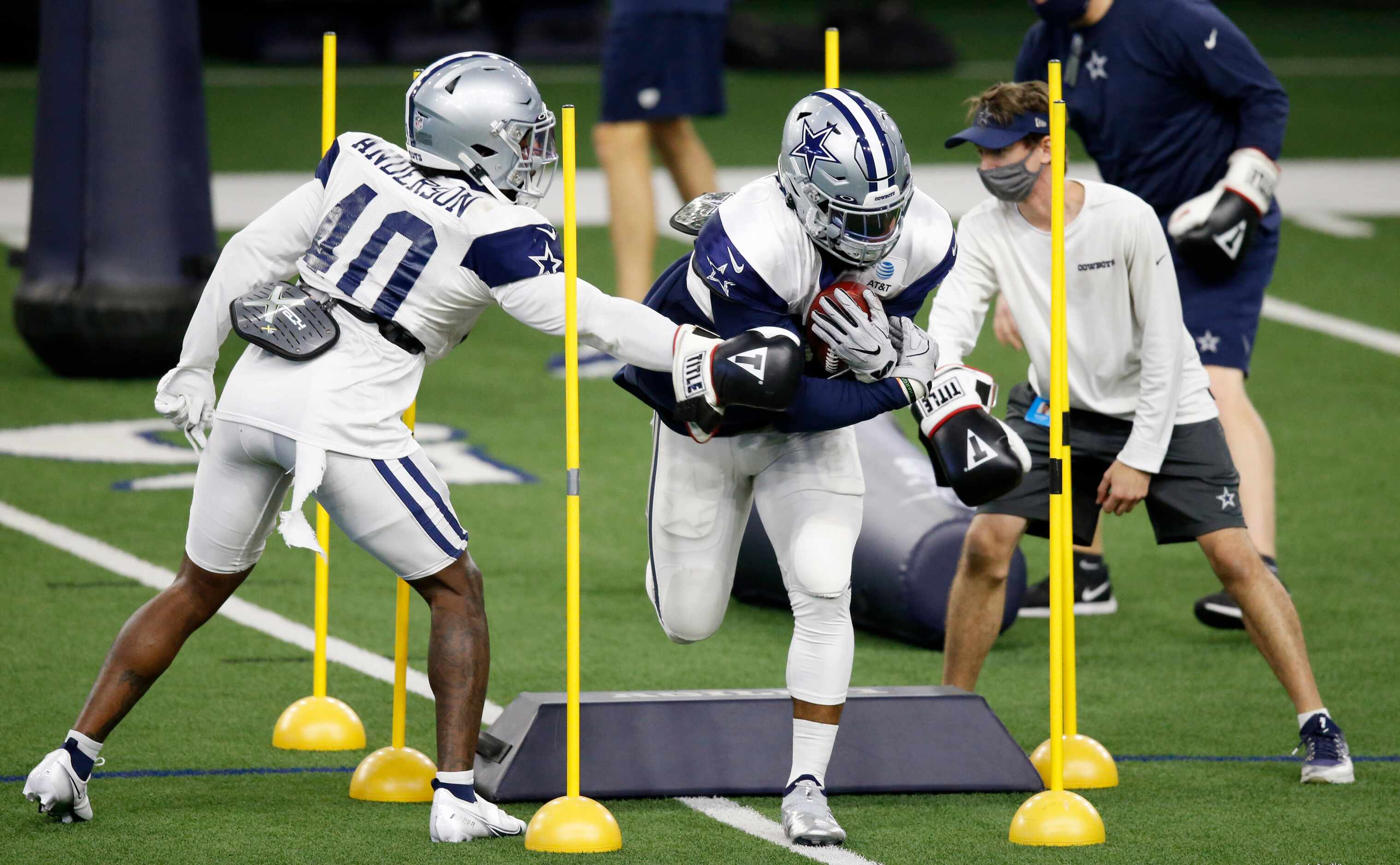 Dallas Cowboys running back Ezekiel Elliott (21) runs through a drill as Dallas Cowboys...