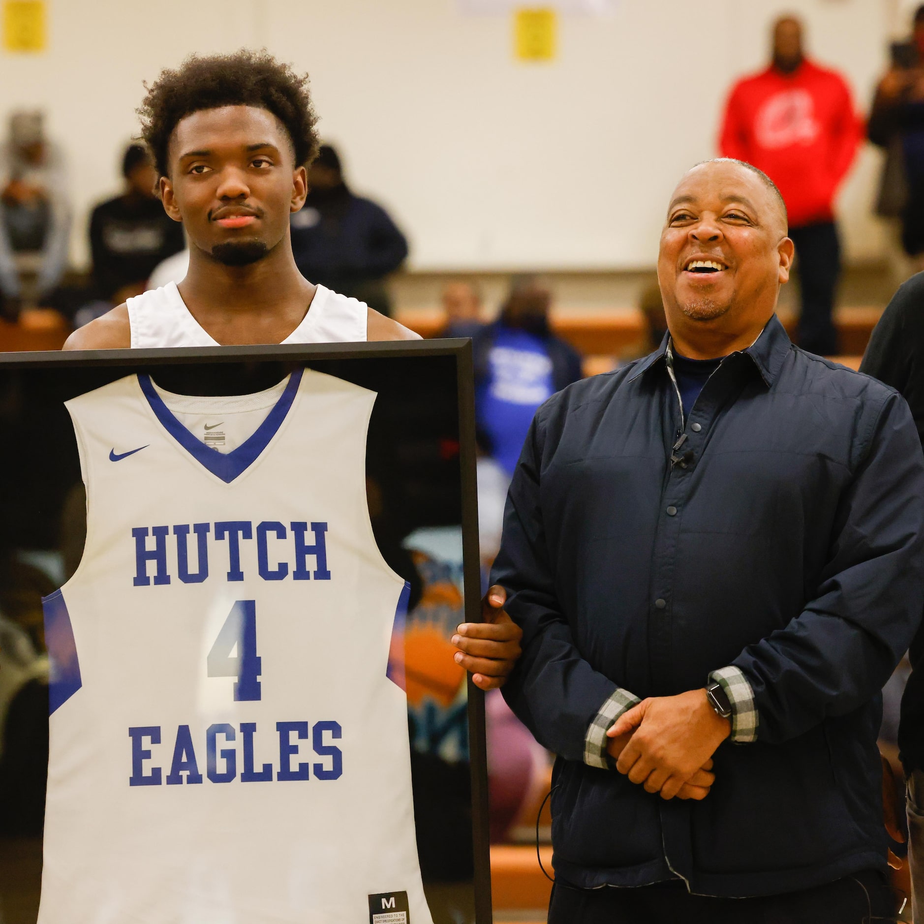 Former NBA basketball player Michael Anthony Jerome "Spud" Webb, right, next to Hutchins'...