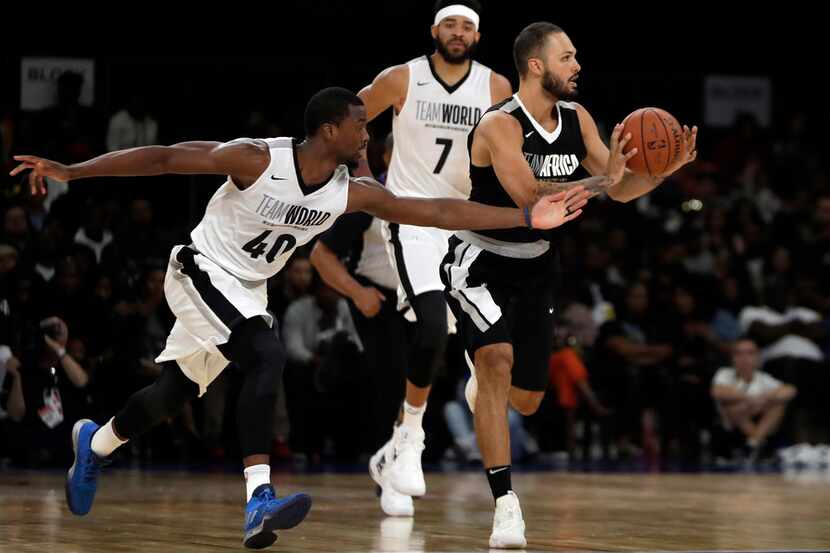 Team Africa's Evan Fournier, right, drives around the ball away from Team World's Harrison...