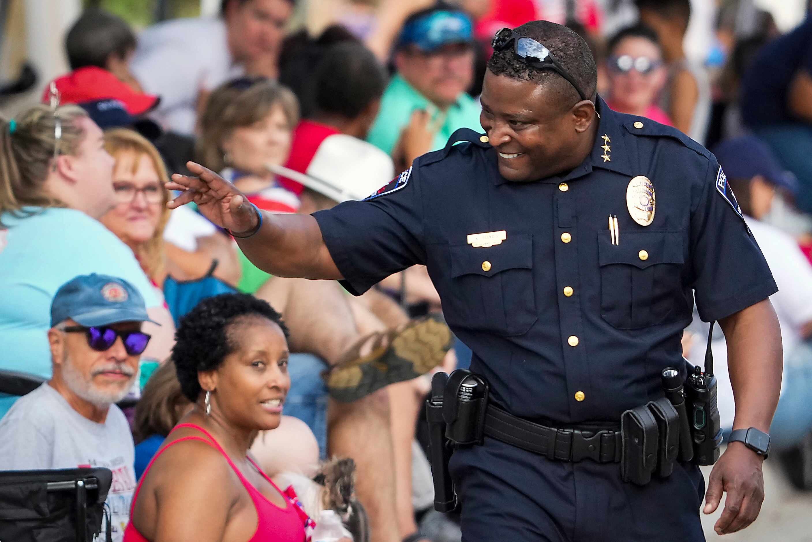 Arlington Chief of Police Al Jones waves to spectators before the Arlington Independence Day...