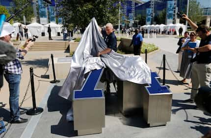 Former Dallas Cowboys defensive tackle Bob Lilly unveils his number in his dedicated area...