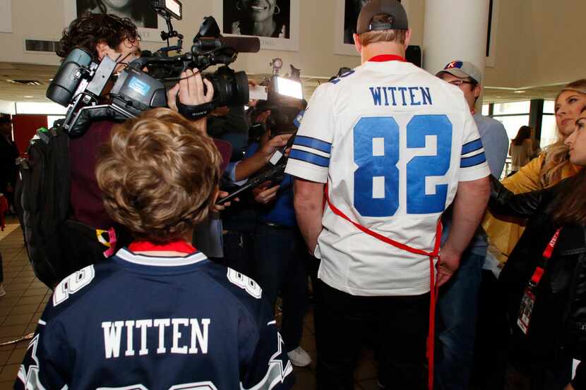 Cooper Witten, 9, left, watch as his father, Dallas Cowboys tight end Jason Witten answers...
