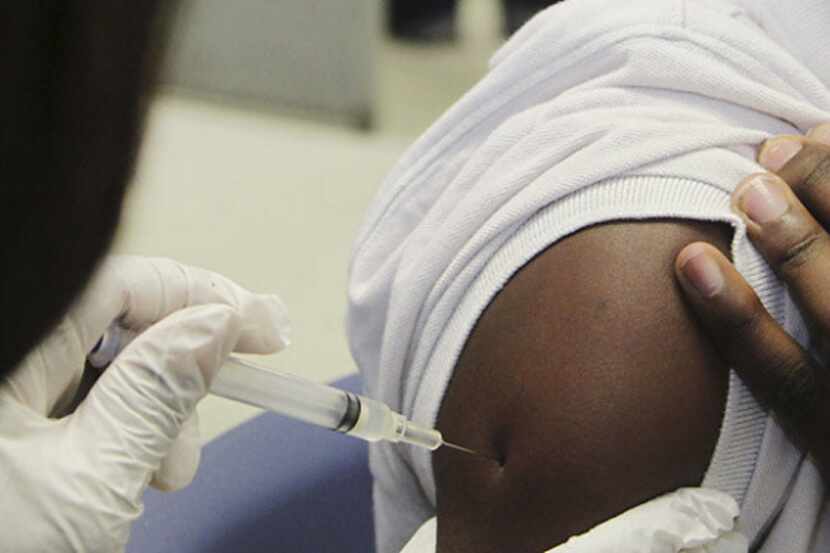 Tyrin Manchester, 12, received a vaccination at the Dallas County Health and Human Services'...