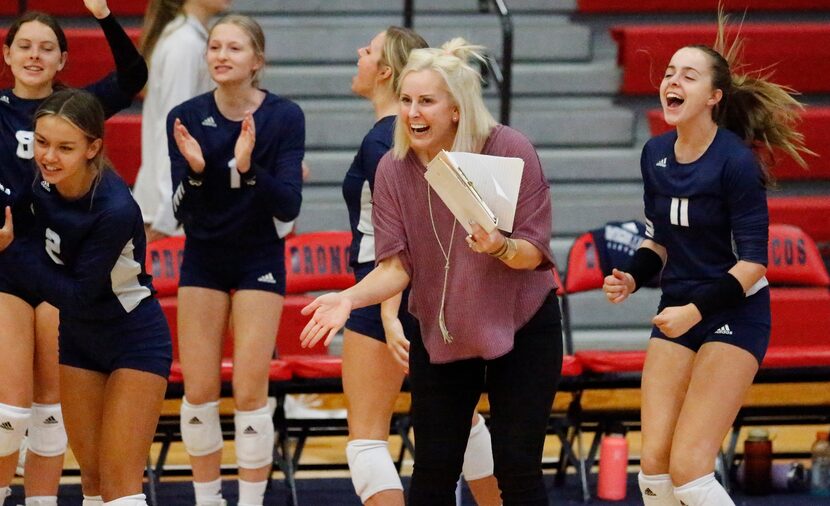 Flower Mound High School head coach Jamie Siegel applauds a point during game one as...