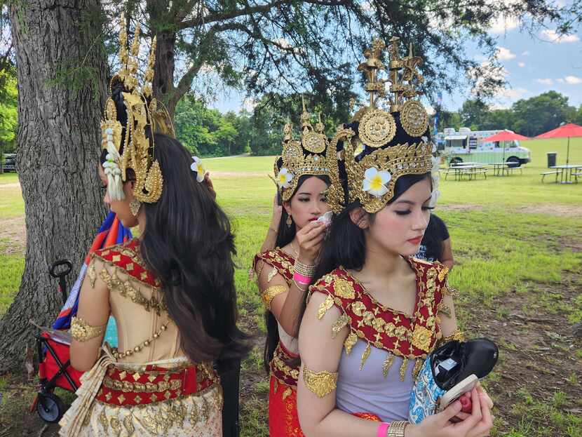 Solina Vong (left), Nina Eng and Natasia Nhan of Selepak Khmer Angkor prepare before their...