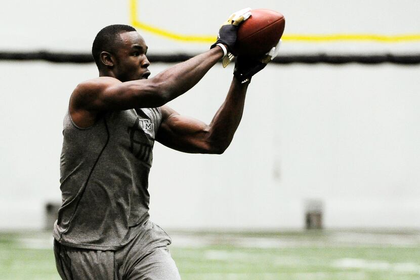 Texas A&M wide receiver Jeff Fuller runs through drills for NFL football scouts during a pro...