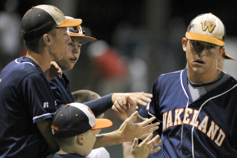 Wakeland pitcher Willie Schwanke (far right) is congratulated after his complete game win...