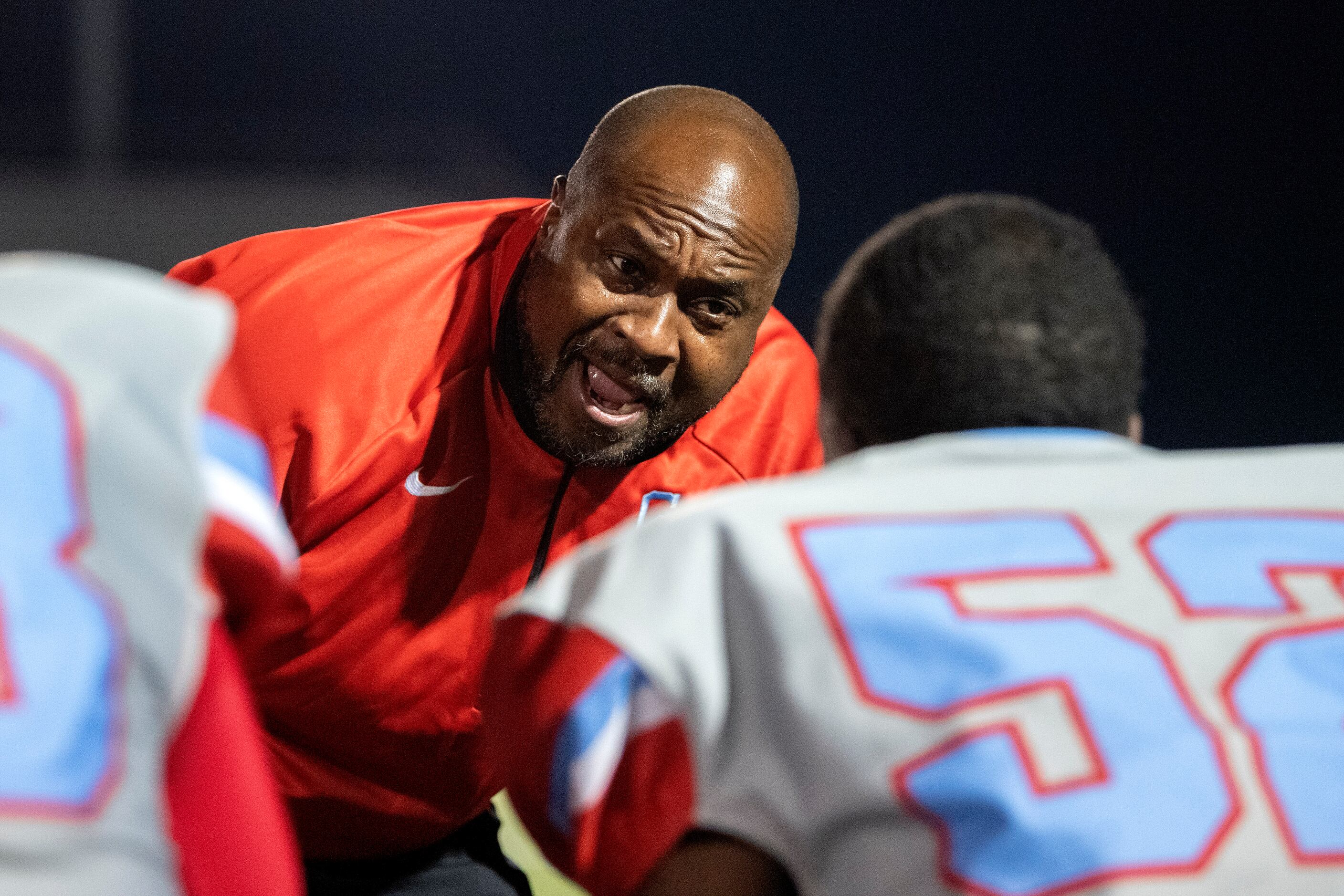 Carter head coach Spencer Gilbert rallies his linemen on the sidelines in the first half of...