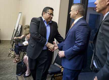 Asad Rahman, general counsel of the Islamic Association of Collin County, (left) shook hands...