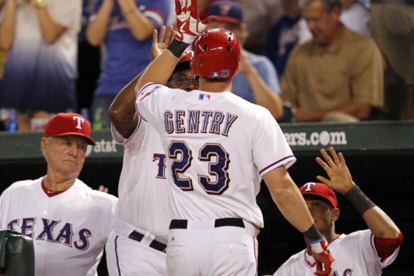 Texas Leonys Martin leaps on the back of Nelson Cruz as the Rangers gather around home plate...