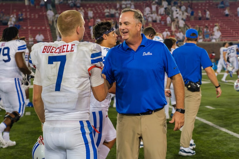 SMU head coach Sonny Dykes congratulates quarterback Shane Buechele after the Mustangs 49-27...