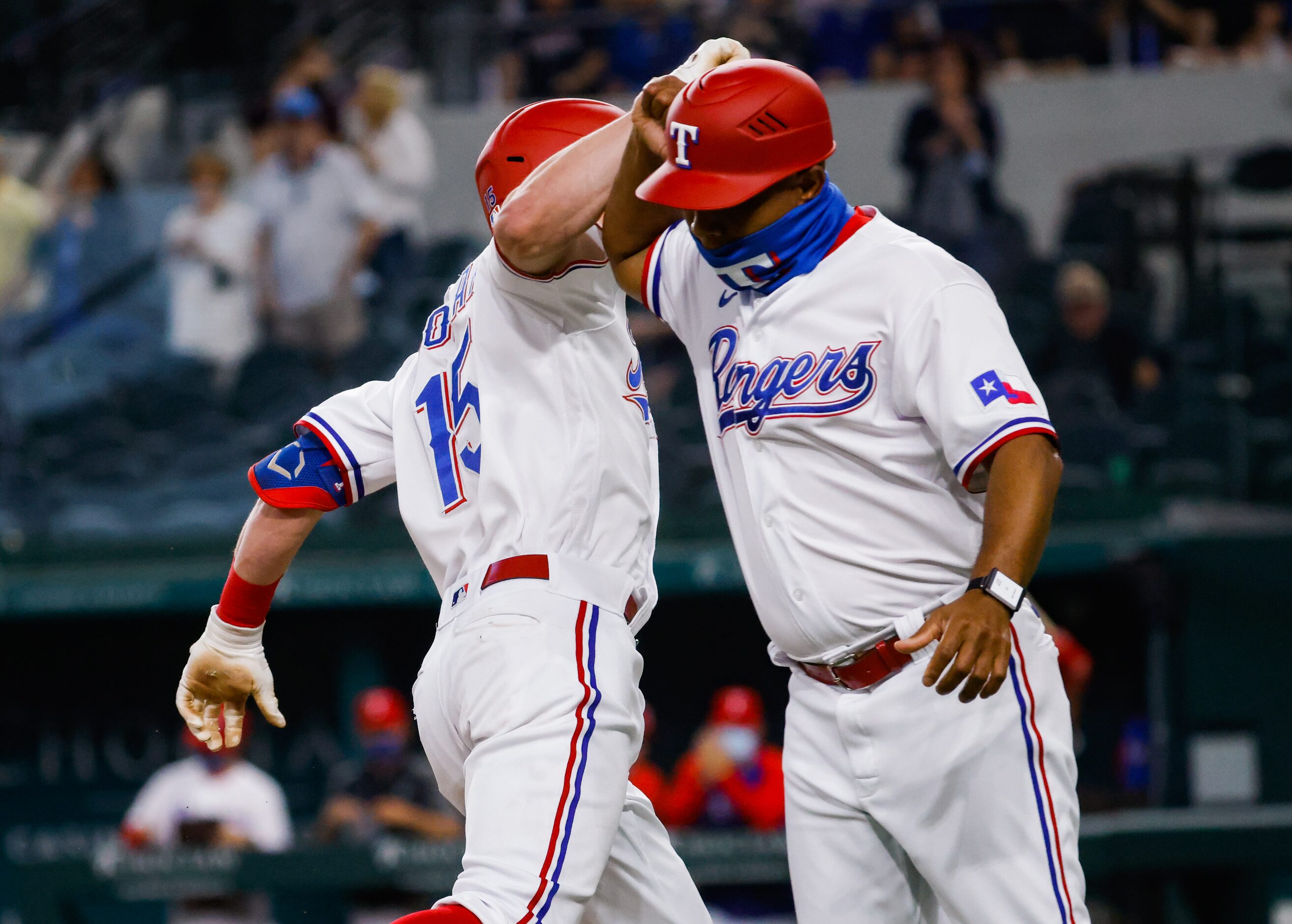 Texas Rangers second baseman Nick Solak (15) elbows Texas Rangers third base coach Tony...