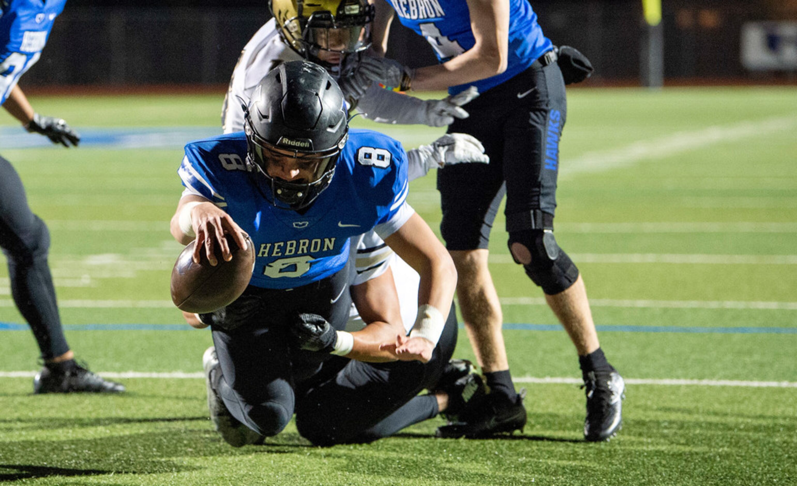 Hebron junior quarterback Carson Harris (8) reaches for the goal line on a touchdown run...