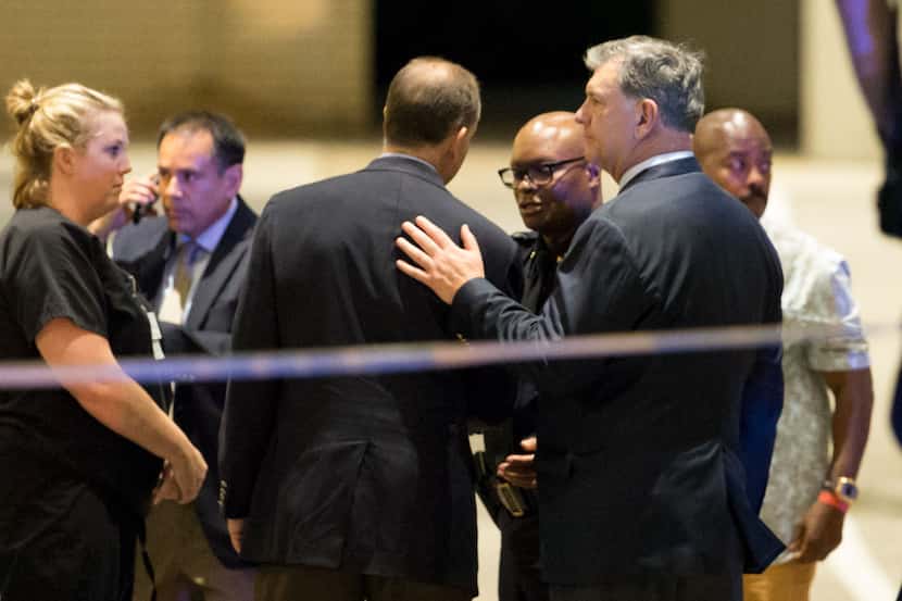 Mayor Mike Rawlings (right) and Police Chief David Brown joined others gathered outside the...