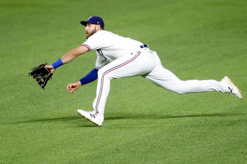 Texas Rangers right fielder Joey Gallo (13) runs down a fly ball and makes a diving catch to...