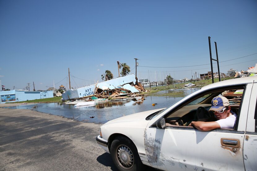 A man drives down South Austin Street in downtown Rockport, Texas on Wednesday, Aug. 30,...