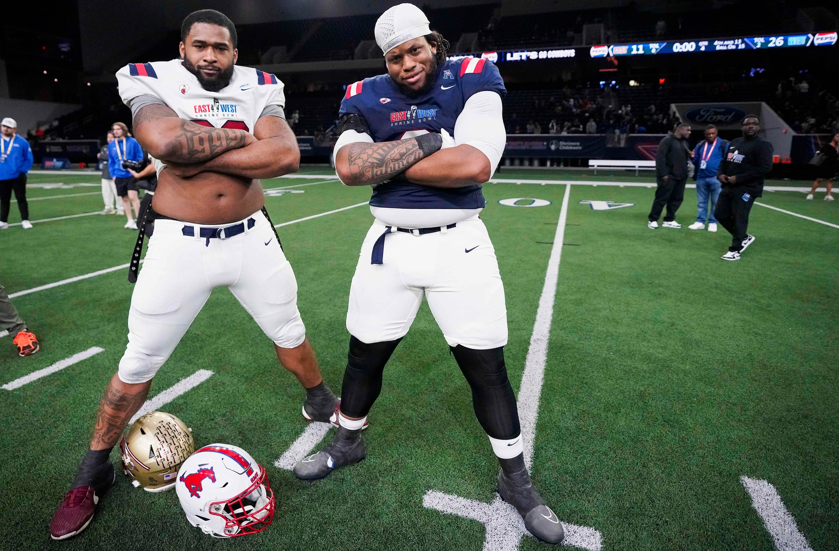 West defensive lineman Jordan Miller of SMU  (right) poses with East defensive lineman...