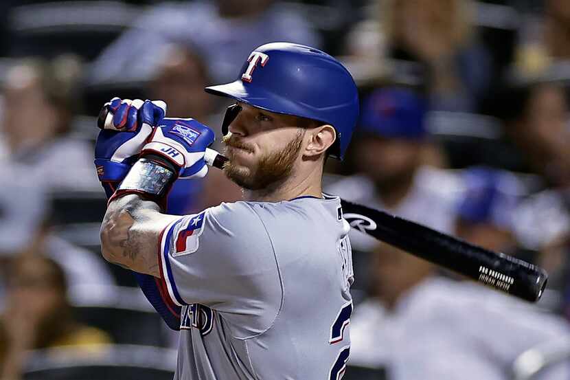 Texas Rangers' Jonah Heim watches a two-run single against the New York Mets during the...