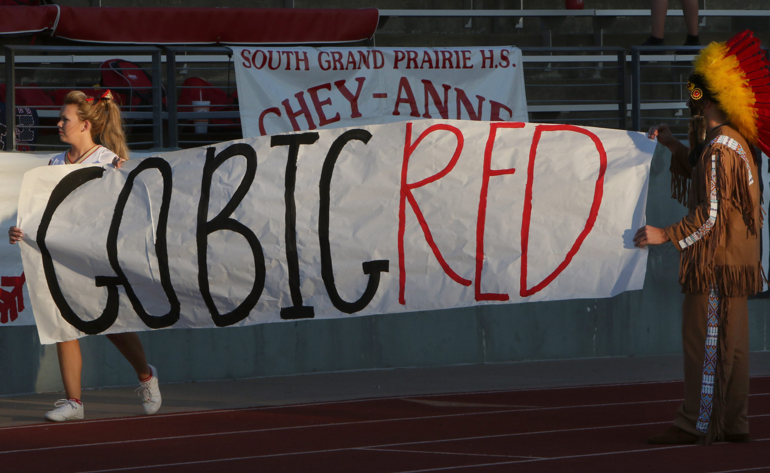 Members of the South Grand Prairie cheerleaders squad place signs prior to the start of...