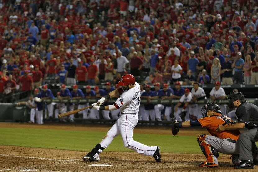 Texas Rangers first baseman Mitch Moreland (18) hits a sacrifice fly to center filed for the...