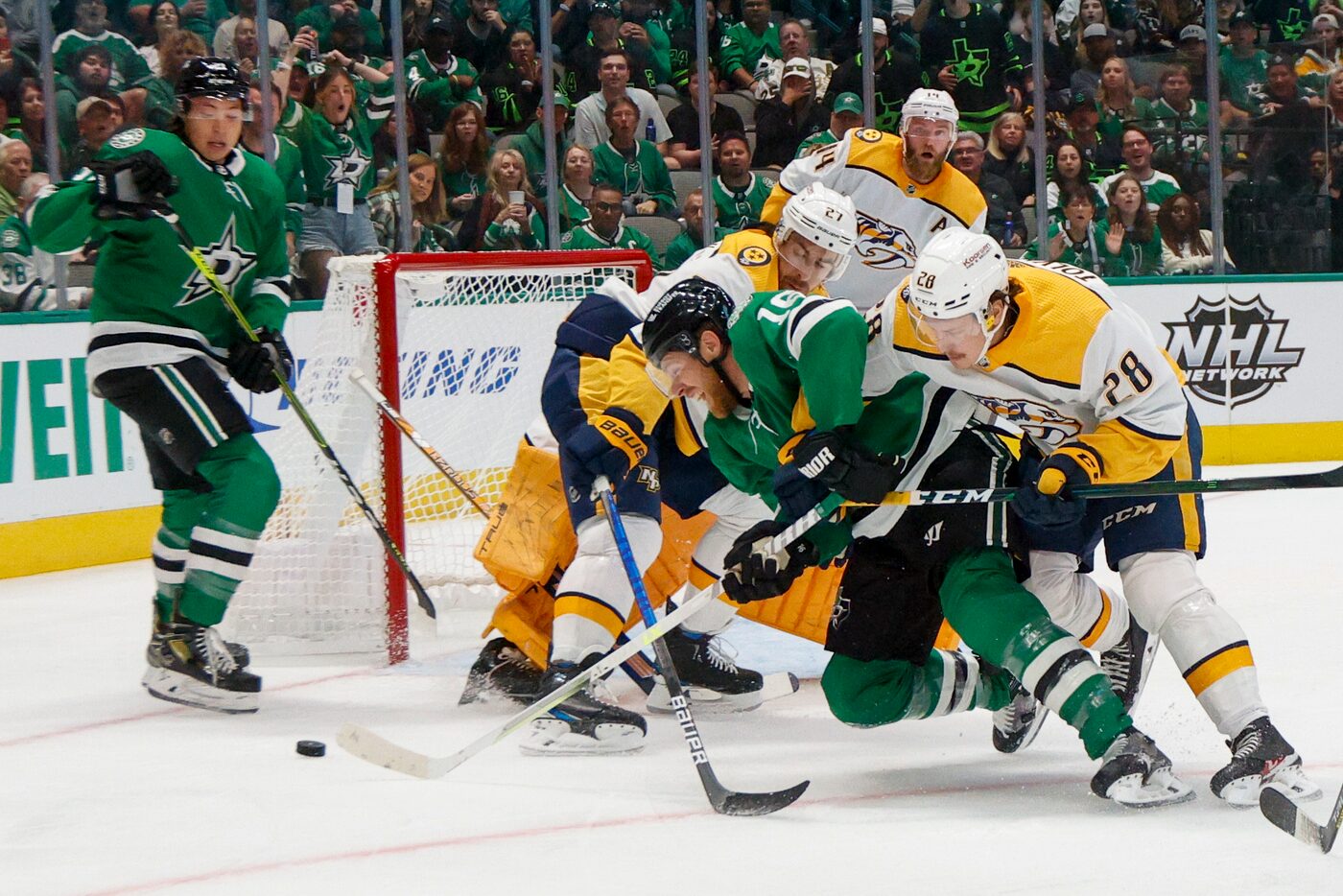 Dallas Stars center Joe Pavelski (16) fights for a loose puck with Nashville Predators right...