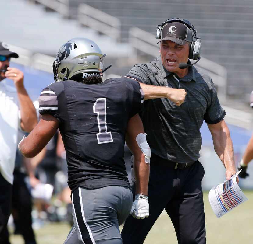 Denton Guyer coach John Walsh celebrates with Kaedric Cobbs (1) after Cobbs scored the...