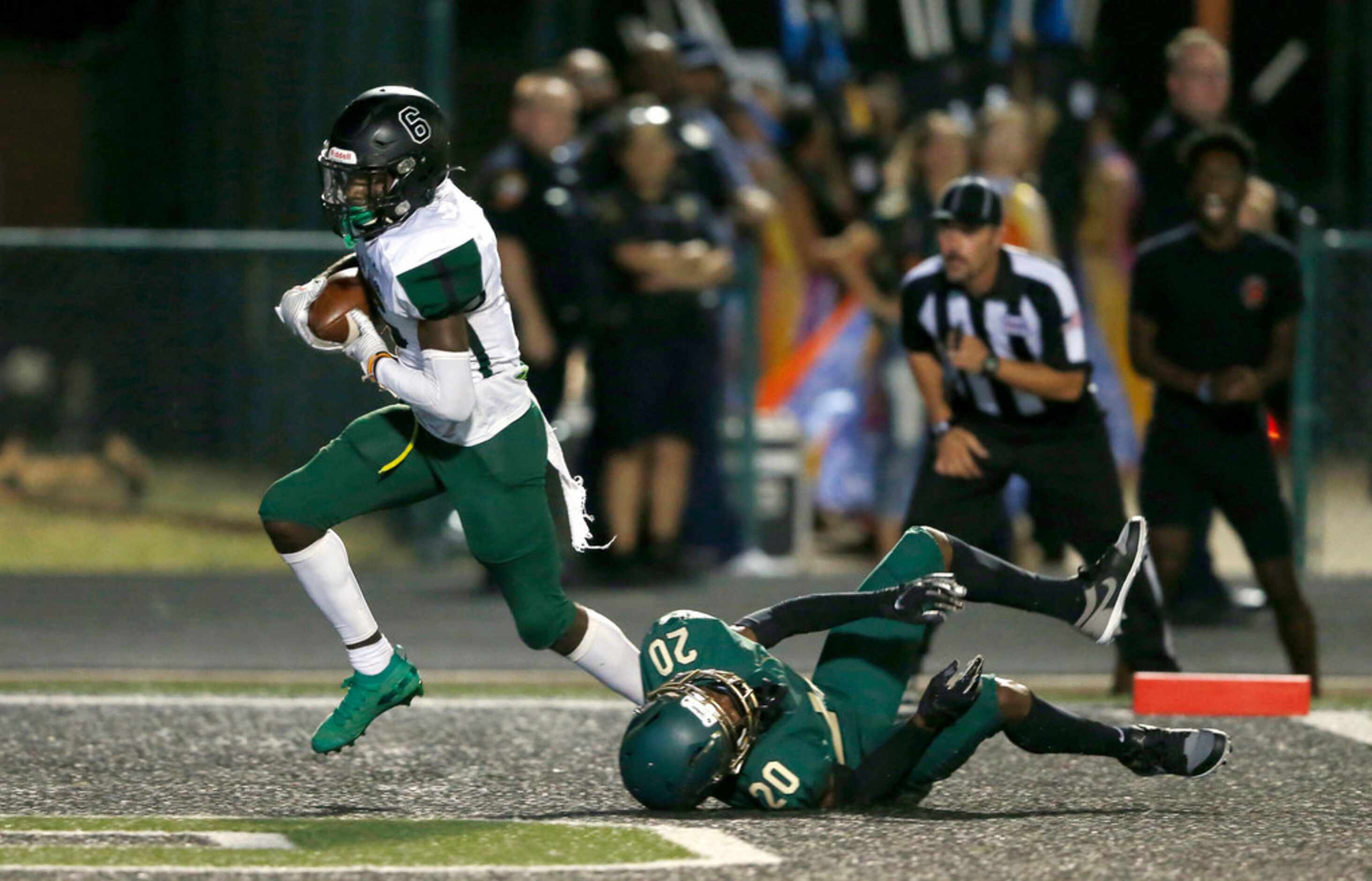 Mansfield Lake Ridge's Cotis Martin (6) scores a touchdown in front of DeSoto's Lathan Adams...