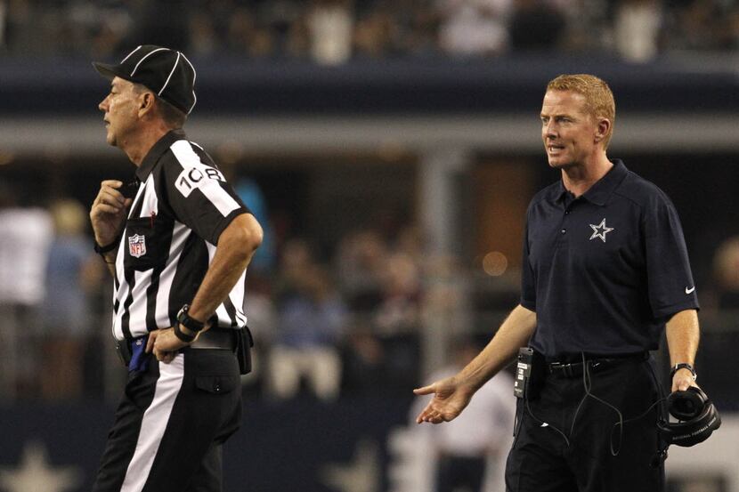 Dallas Cowboys head coach Jason Garrett questions a penalty in the first half of NFL...
