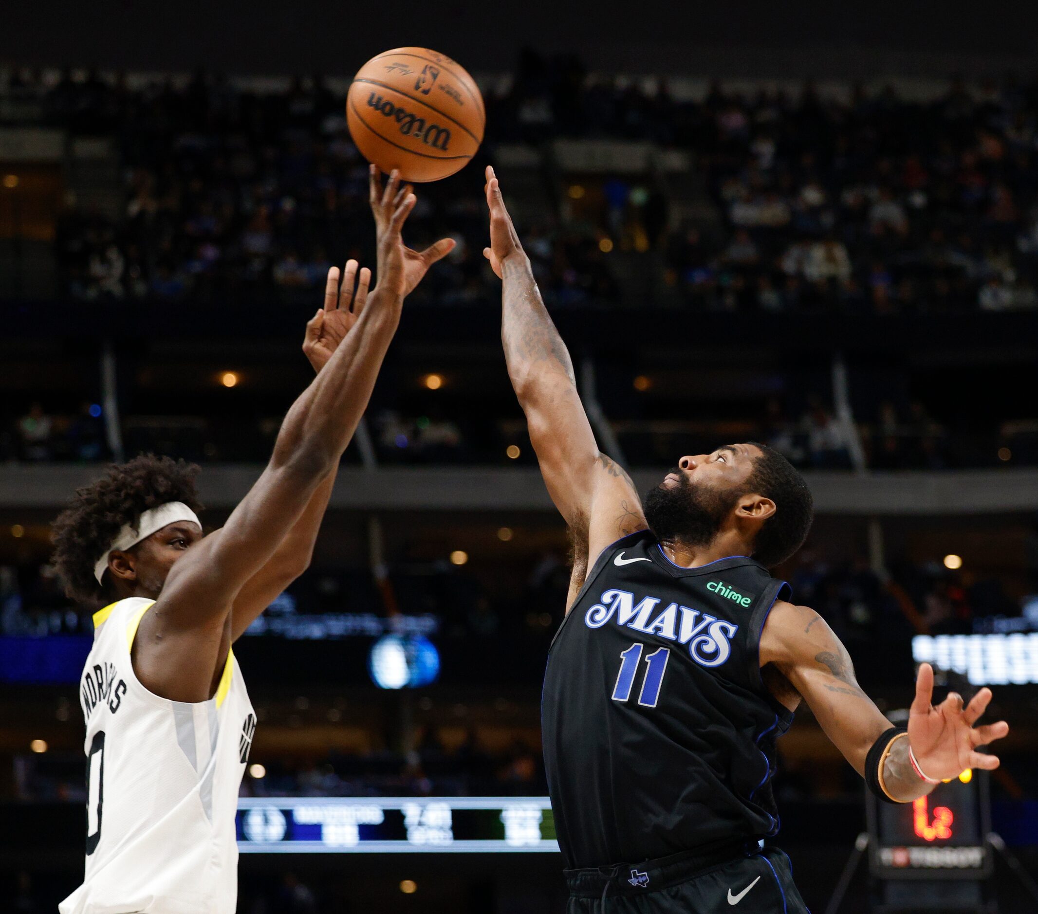 Dallas Mavericks guard Kyrie Irving (11) contests a shot from Utah Jazz forward Taylor...