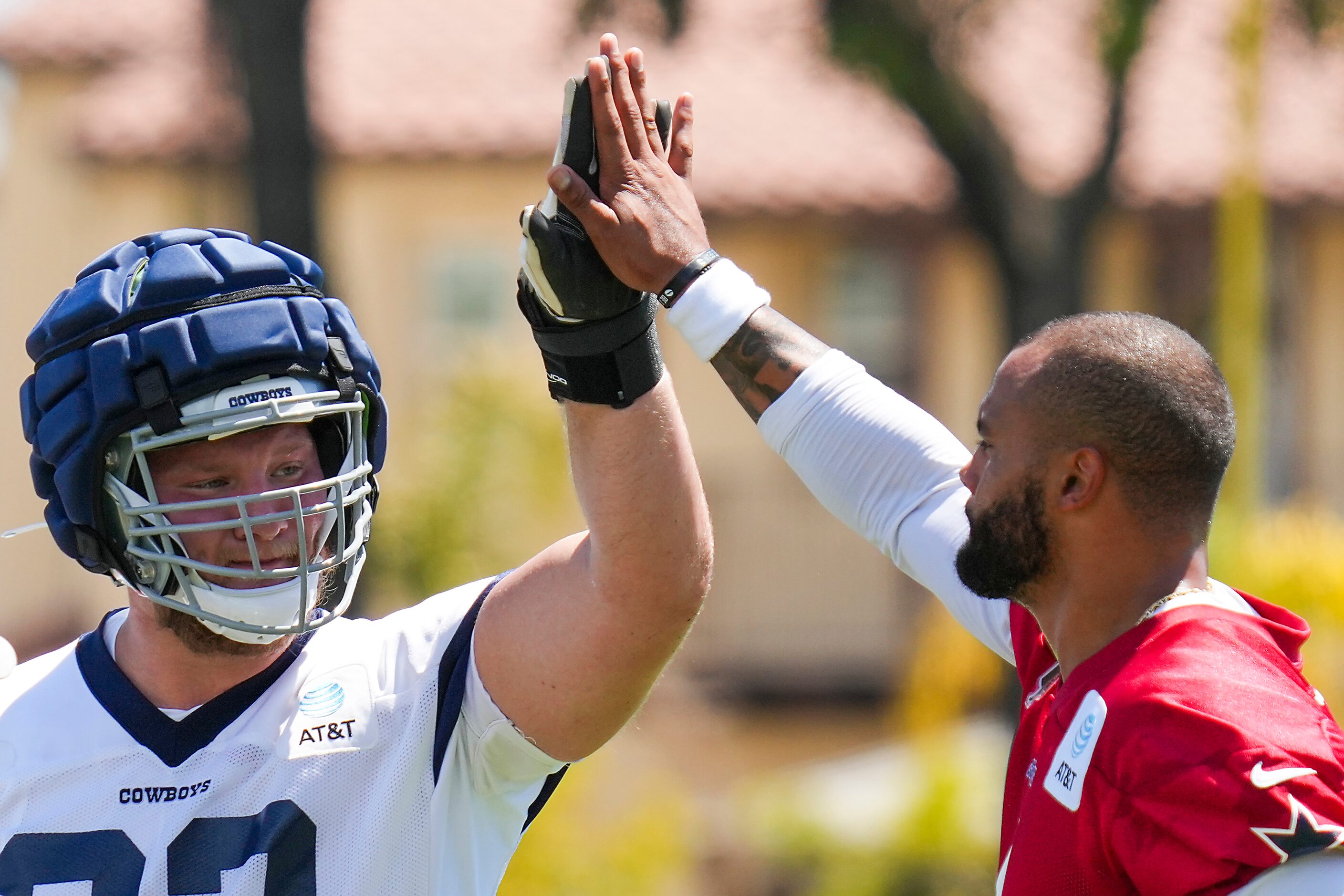 Dallas Cowboys center Tyler Biadasz (63) high fives quarterback Dak Prescott (4) during the...