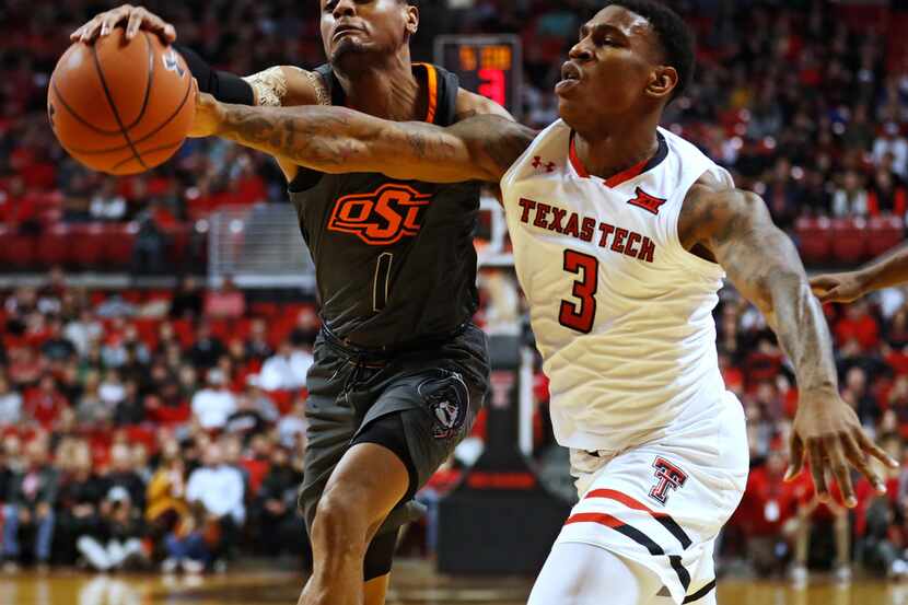 Oklahoma State's Curtis Jones (1) knocks the ball away from Texas Tech's Deshawn Corprew (3)...