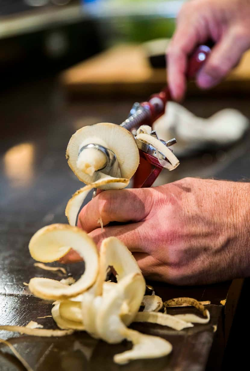 Chef Graham Dodds uses a spiralizer on a radish on Thursday, March 31, 2016 at Wayward Sons...