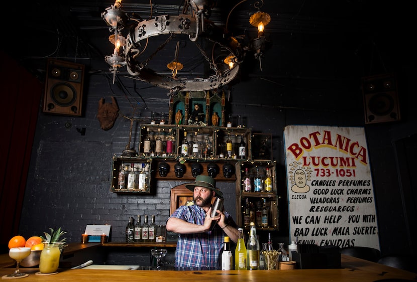 Bartender Chris Dempsey mixes a Malverde drink, which contains tepache, at Las Almas Rotas...